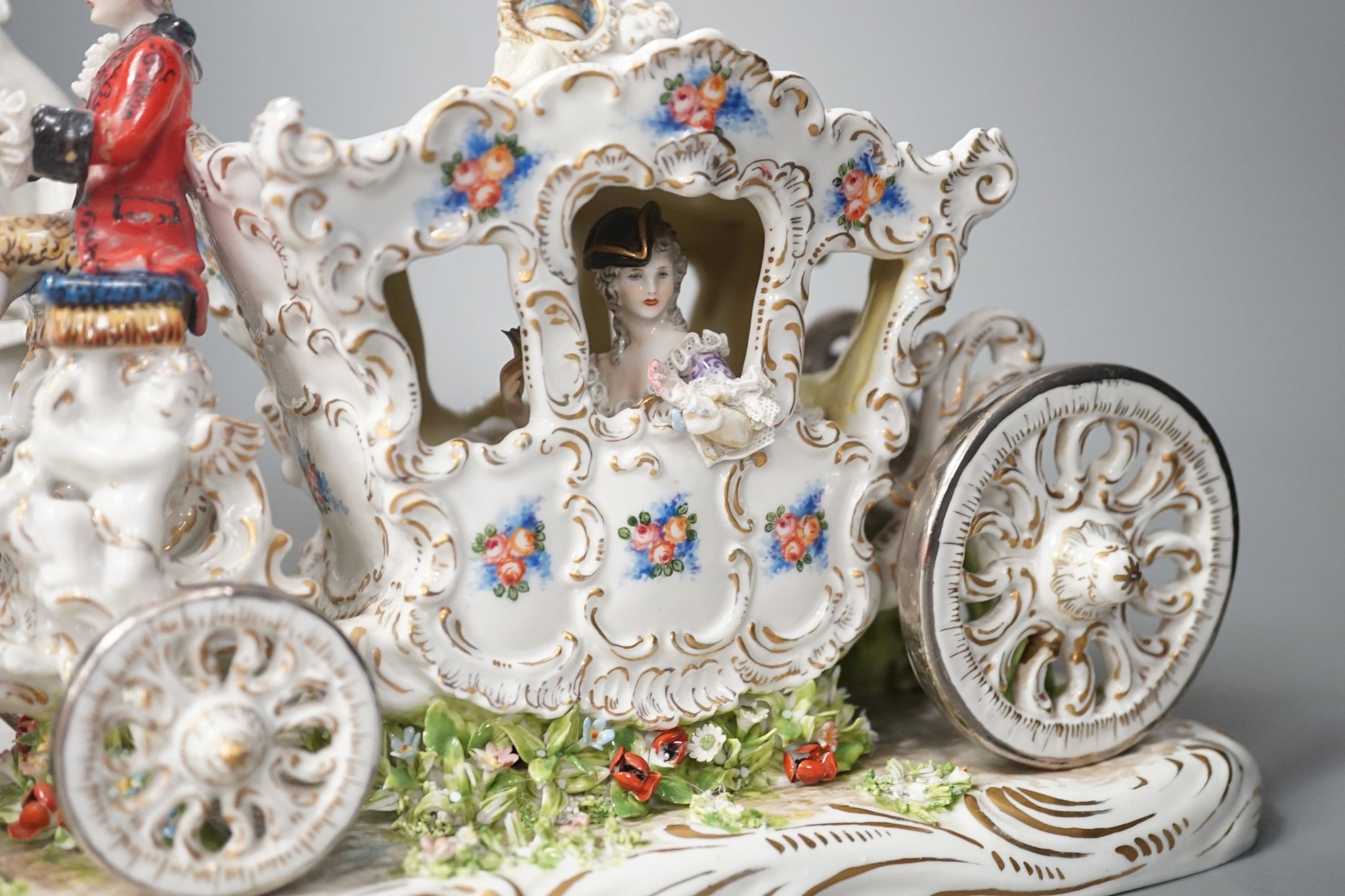 A large Italian porcelain carriage group and a pair of Italian white porcelain figure of a lady and a man 54cm
